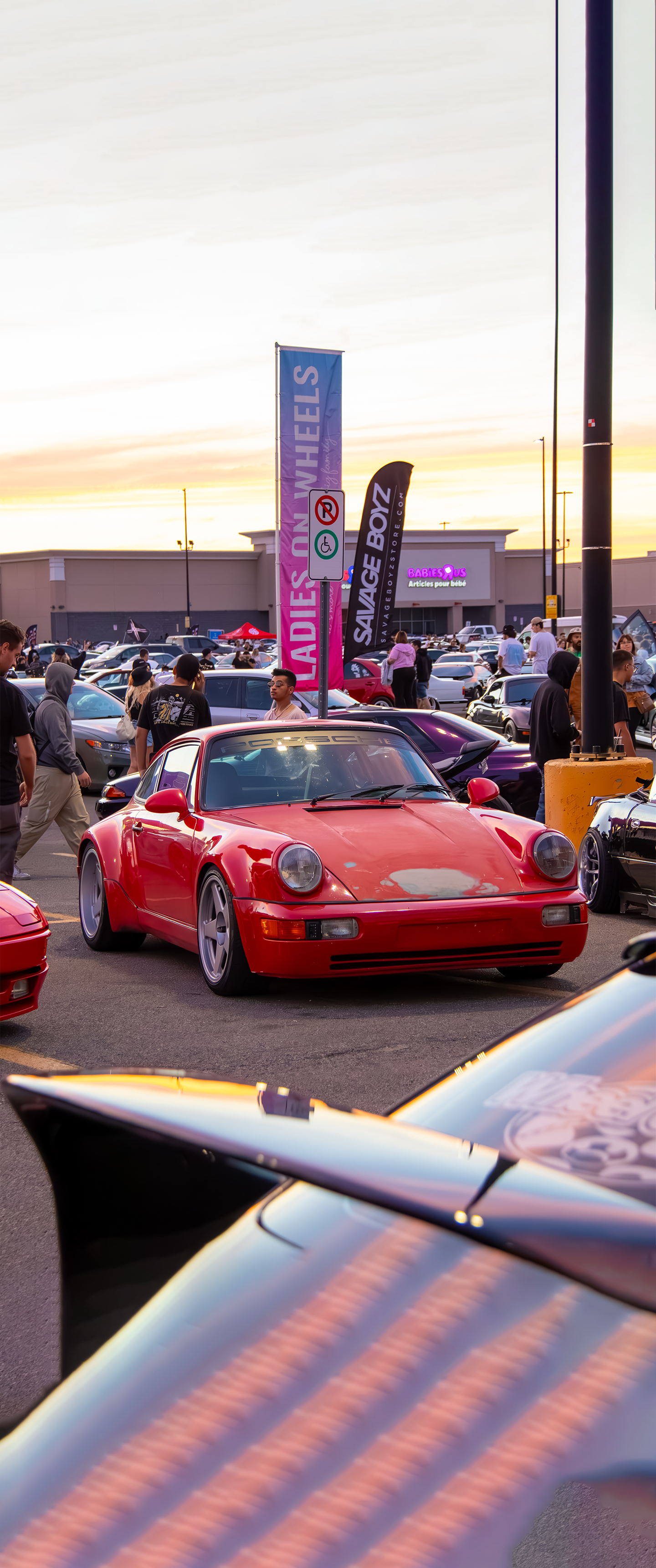 Photo of a Porsche 911 964 in red at a festival