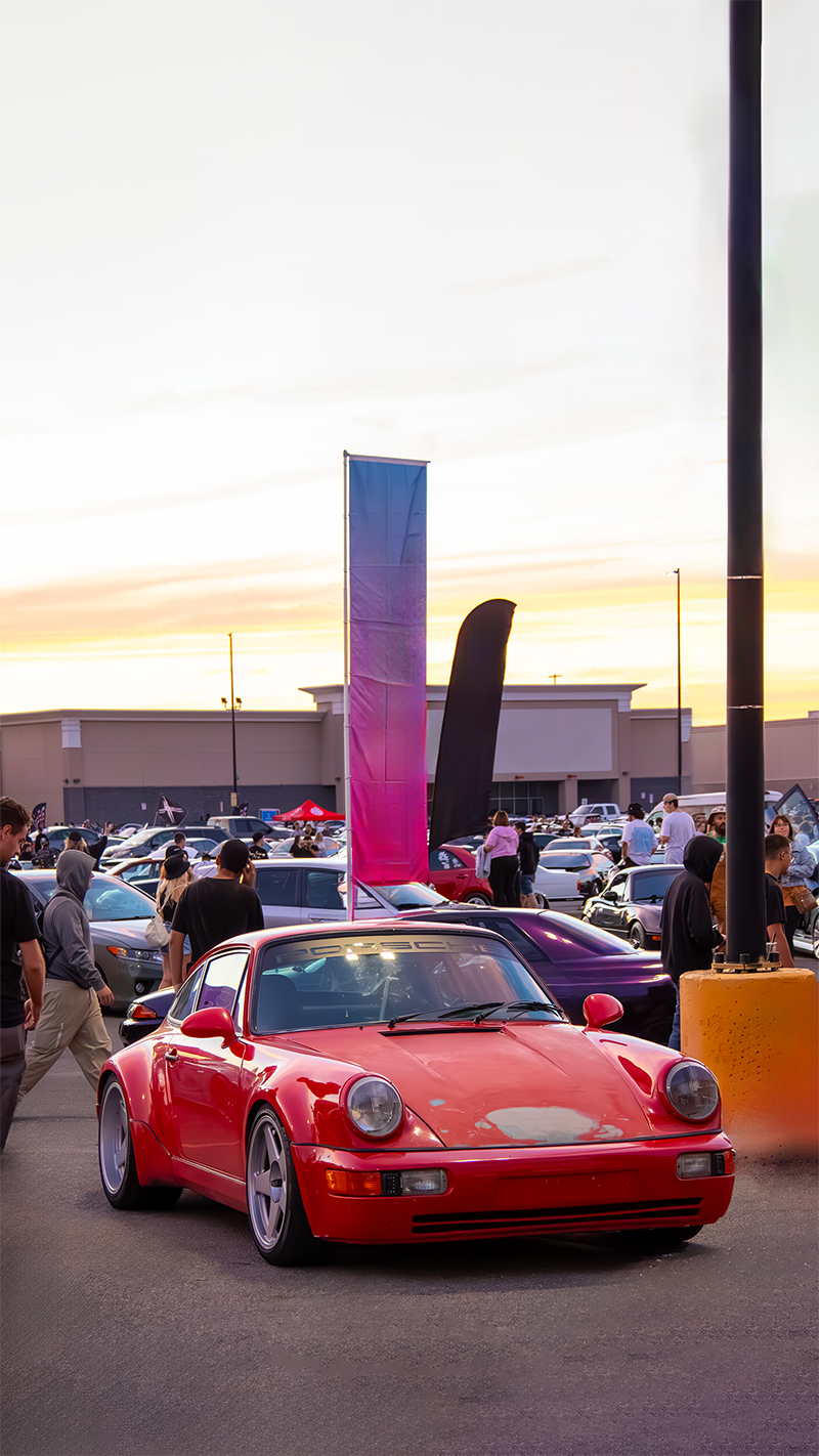 Photo of a Red Porsche 911 964 in a festival